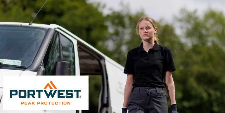 A woman in a black polo shirt and grey work trousers stands outside in front of a white van. Green trees can be seen in the background. The "Portwest Peak Protection" logo is at the bottom left of the picture.