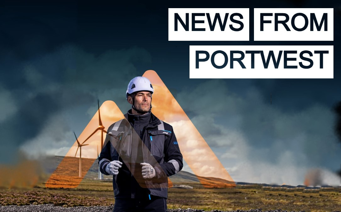 Worker in work clothing and with a white safety helmet in front of a wind farm with hills and dark clouds. The Portwest logo is in transparent orange. In the top right of the picture is the heading "News from Portwest" in transparent, white-backed letters.